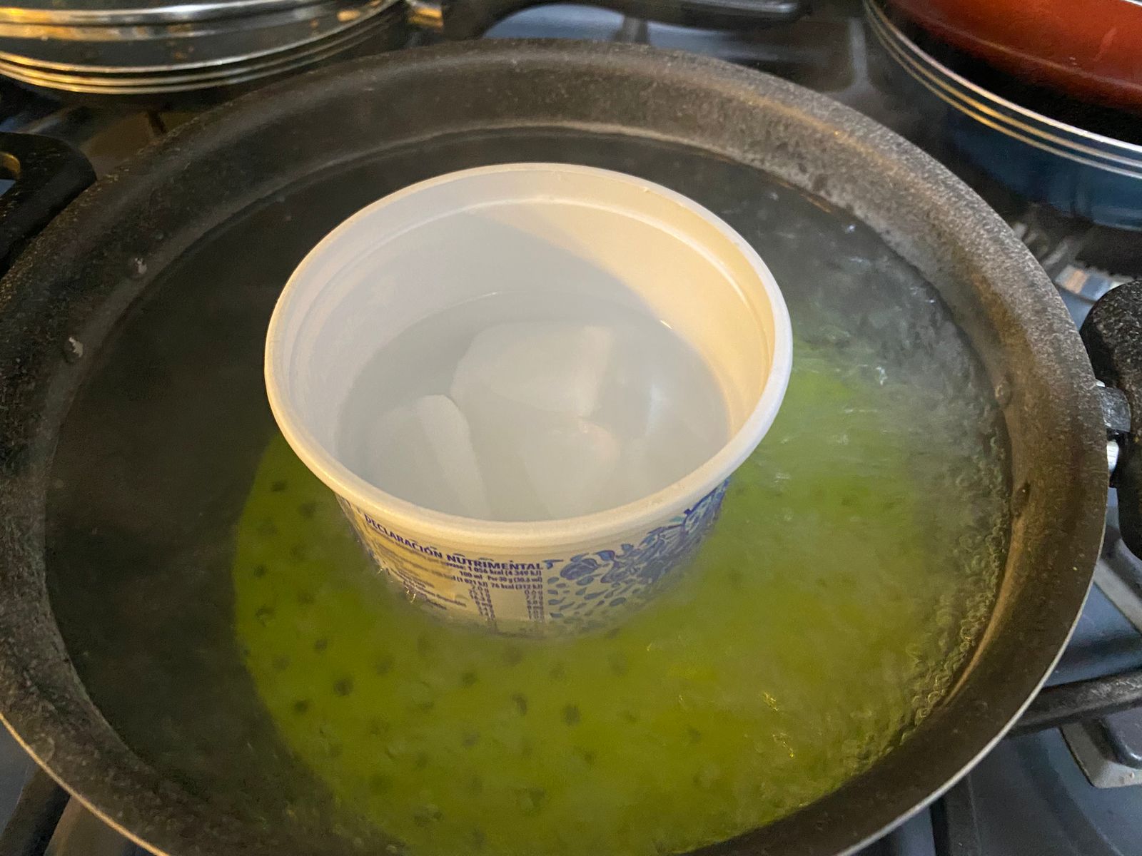 Melting the wax candle in a double boiler