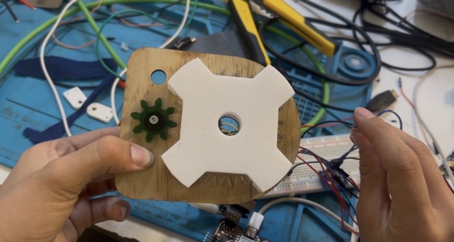 Second laser cut plywood piece showing fit test with the mechanism