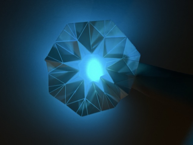 Final kinetic origami panel in its fully open state — the flower-like structure expanded to its maximum position