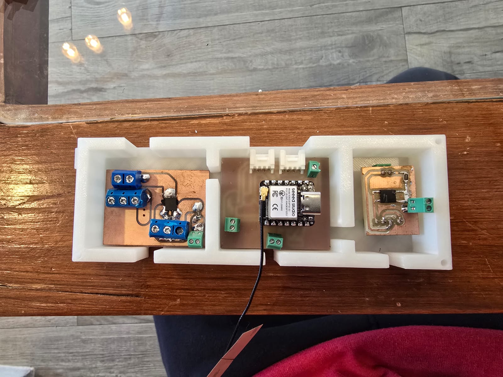 Electronics compartment showing the XIAO ESP32-S3, the MOSFET driver stages and the screw terminals for the 12 V loads