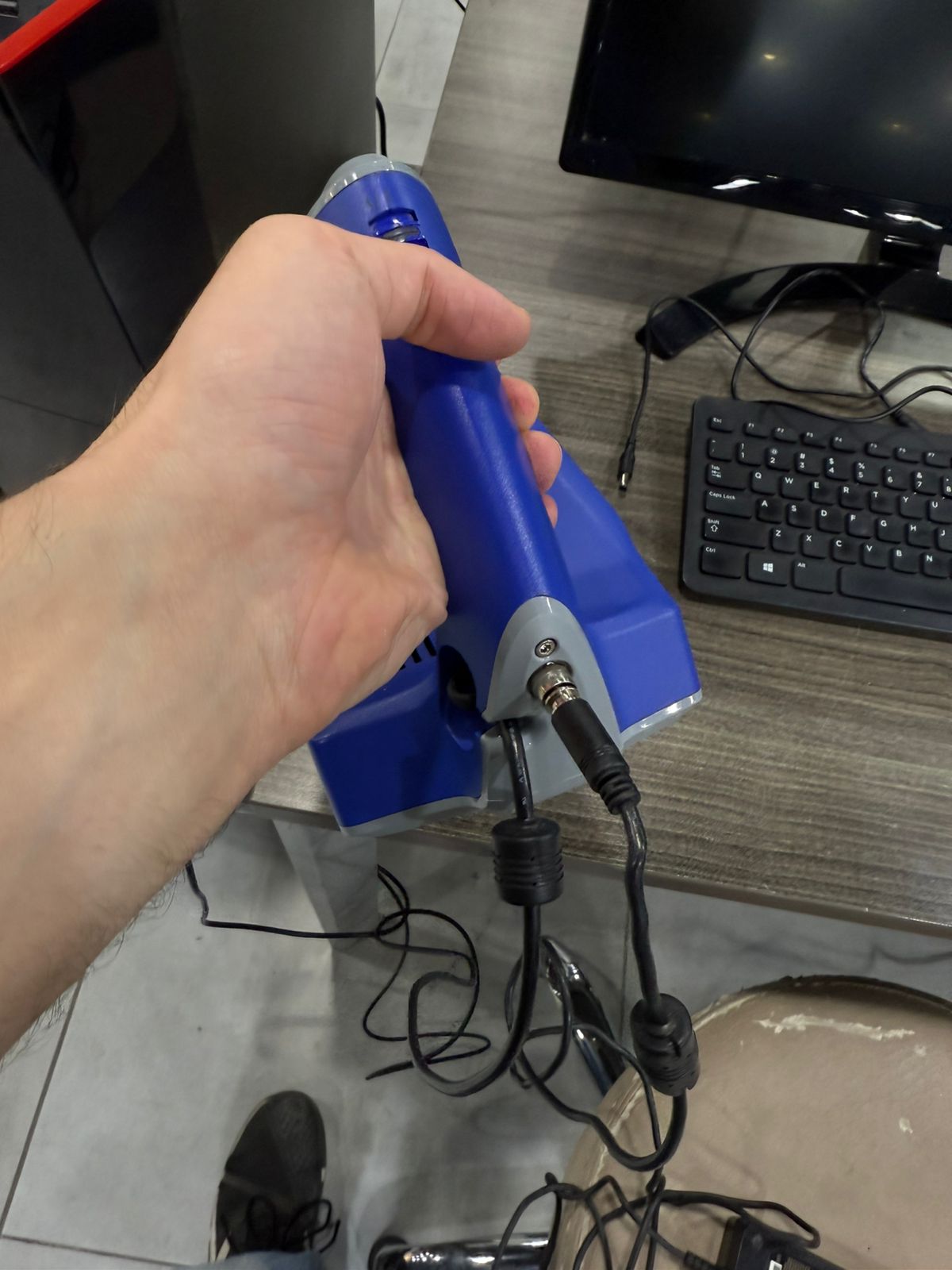 Connecting the main power supply and routing the USB data interface cables to the workstation.