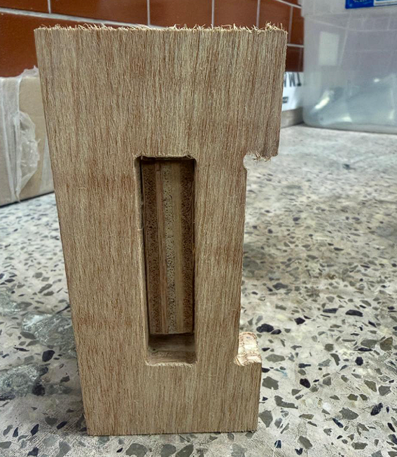 Machined plywood piece with slot and dog-bone corner relief
