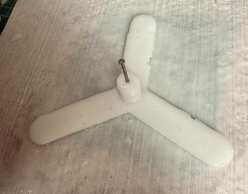 Cured silicone tentacle with nail still inserted in center post