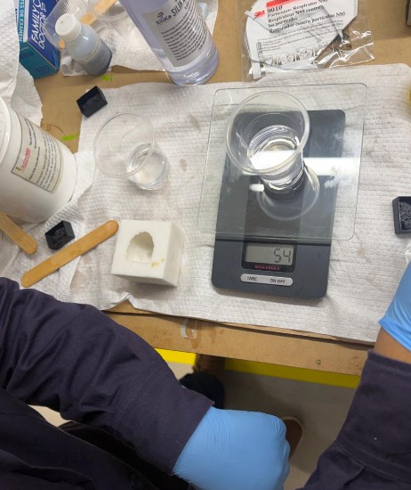 Mixing and pouring epoxy into the Chavín mold
