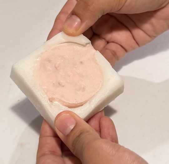 Soap cast being removed from mold