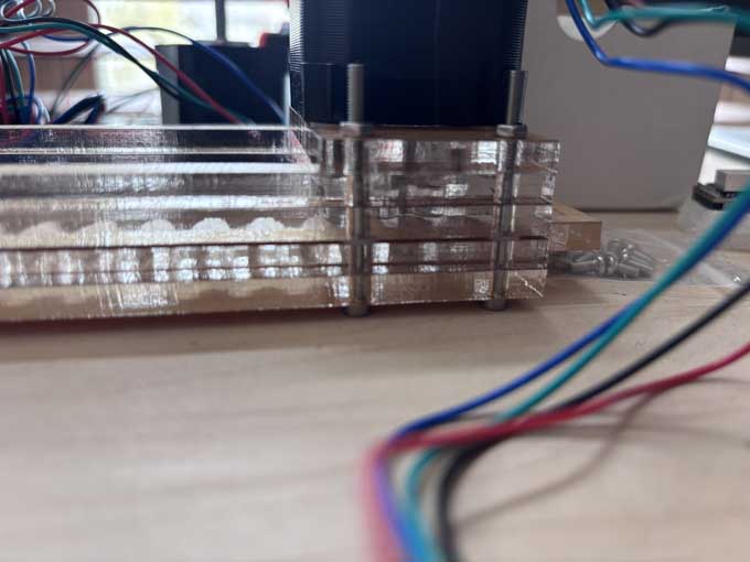 I used nylon washers between the spacer layer and the lip to increase the space for the rack gear to slide. I added five