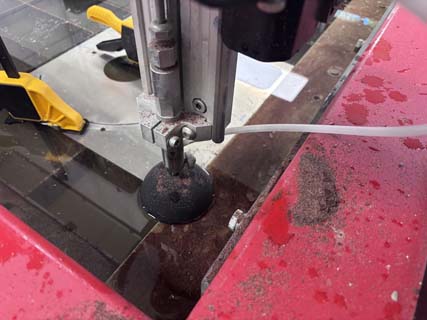 Lowering the spray shield before machining