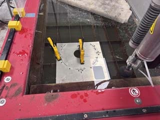 Clamping down the stock material on the waterjet bed