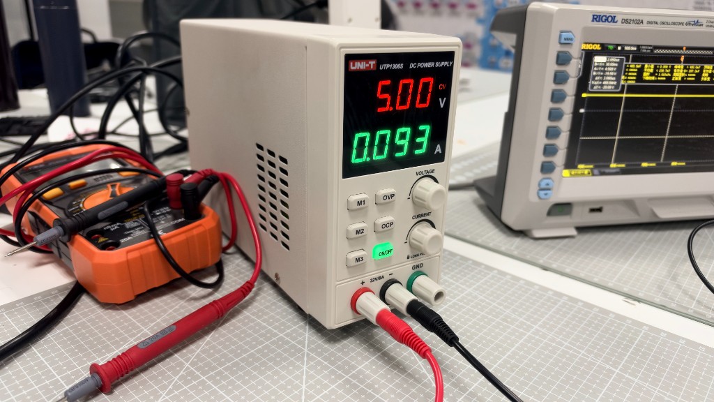 Bench supply, multimeter, and oscilloscope on the lab mat