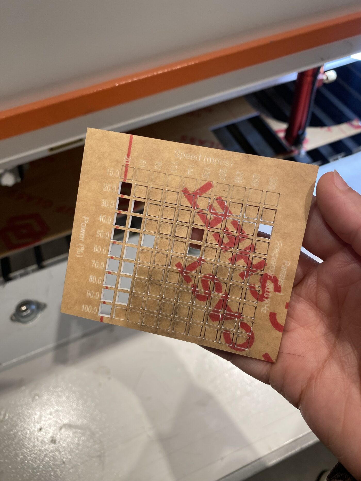 Acrylic test sheet after cutting, showing which power/speed combinations cut cleanly