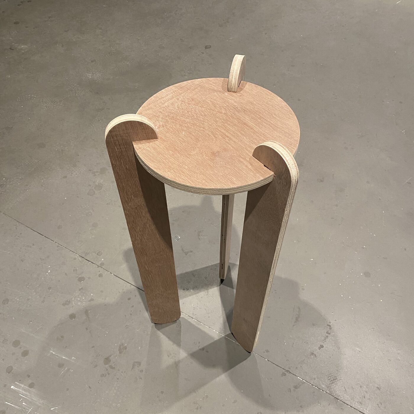 Final assembled press-fit plywood stool standing complete with no fasteners