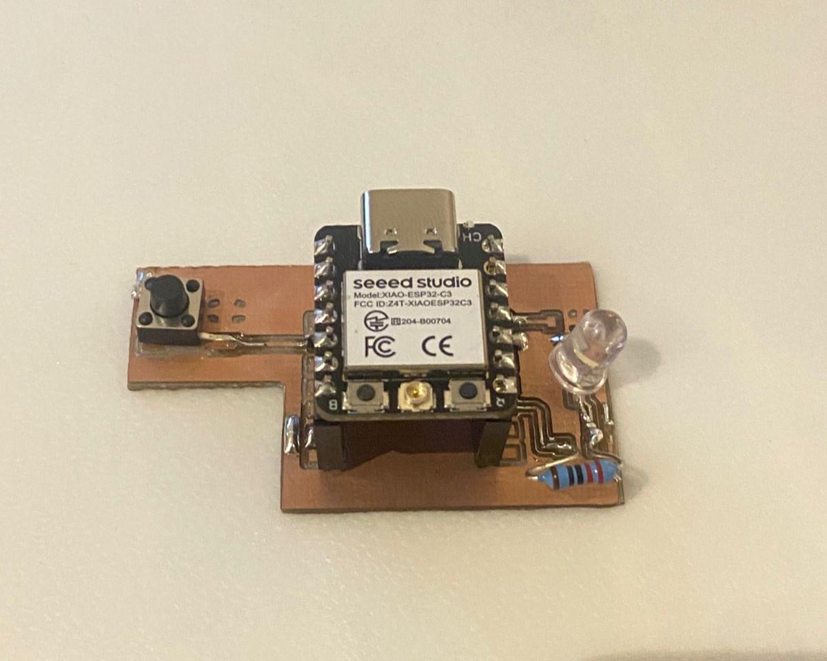 Fully soldered PCB with XIAO ESP32-C3, LED, button, and resistor