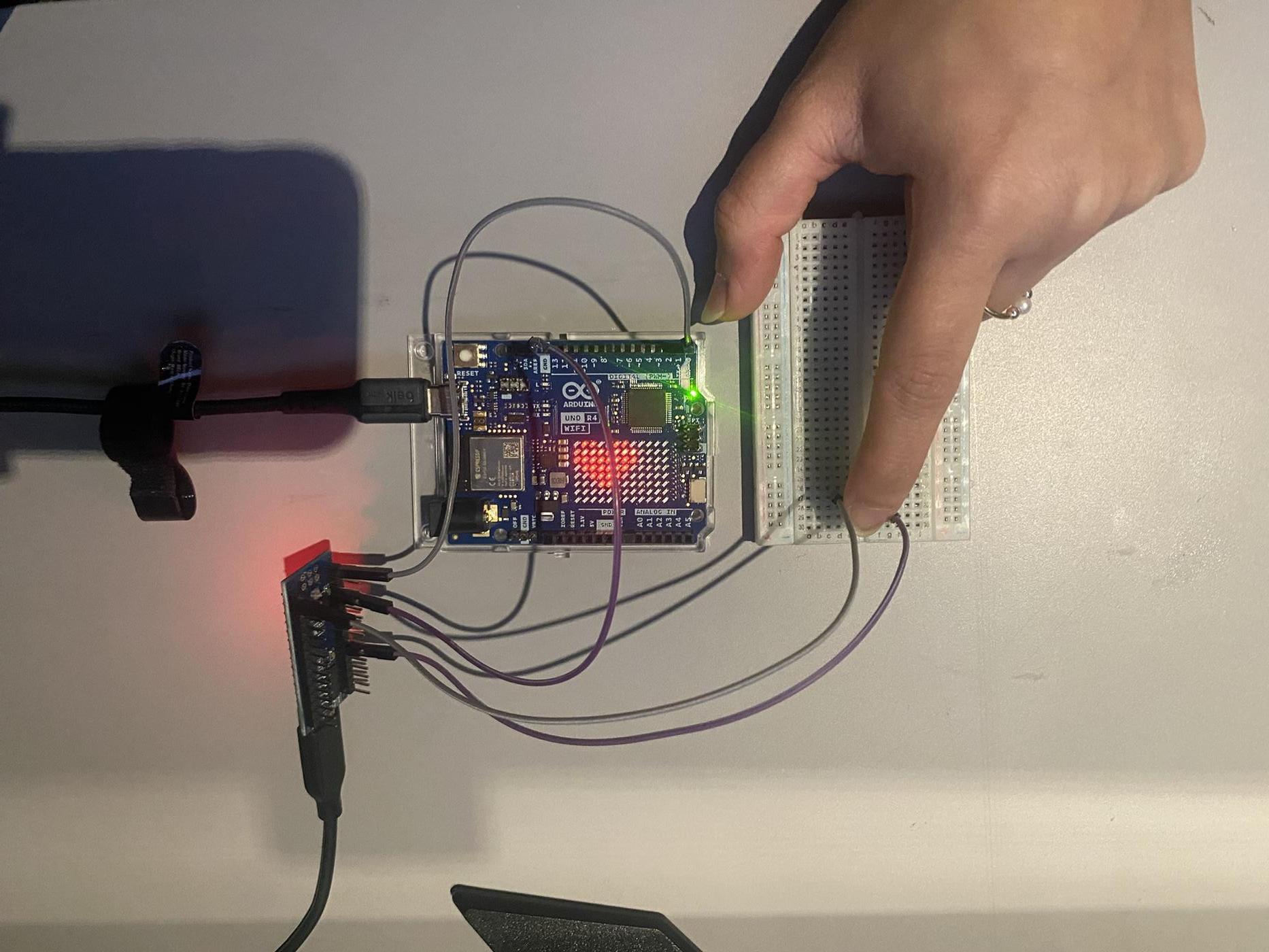 Arduino UNO R4 WiFi showing heart animation on LED matrix after receiving PRESS message
