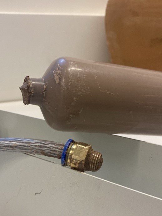 Clay-filled canister with the brass extrusion nozzle attached