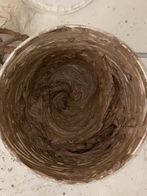 Bowl of clay mixed to a thick, smooth, mud-like consistency ready for the canister