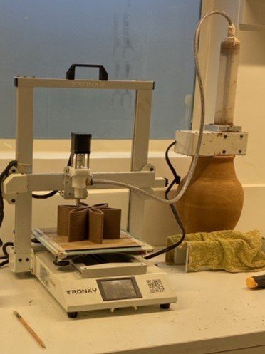 The completed clay flower print sitting on the Tronxy printer's build plate