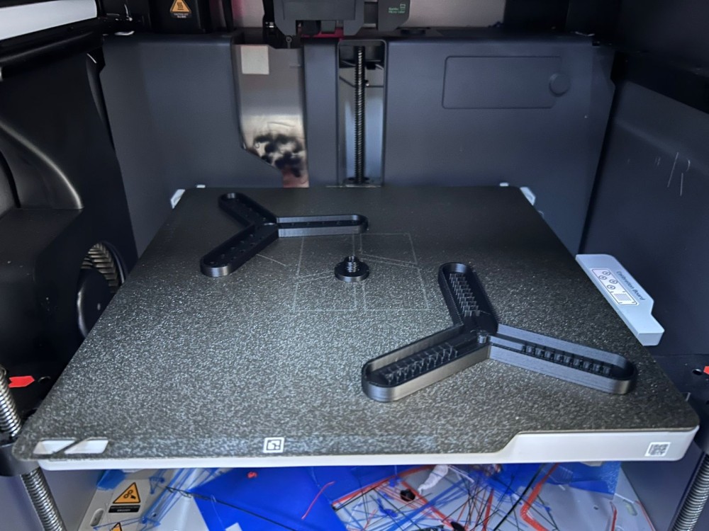 Both mold halves printed in PLA on the 3D printer bed, ready for post-processing