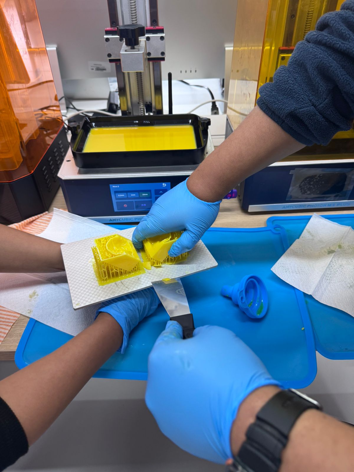 Resin mold removed from build plate with gloves