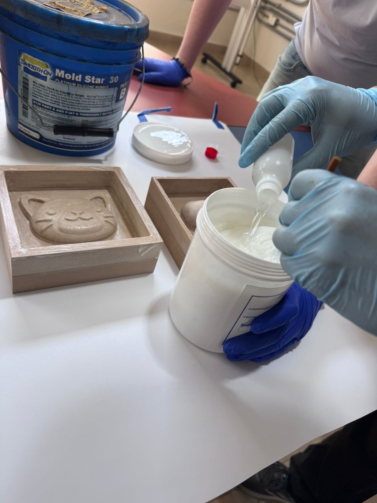 Silicone component poured into mixing container