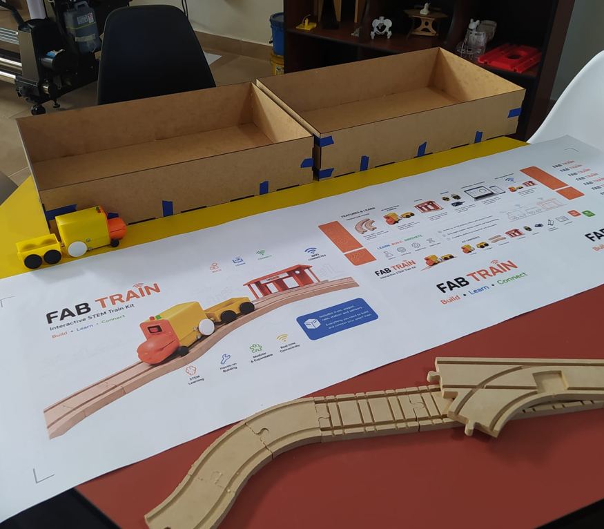 Application of plotter-cut adhesive vinyl to the Fab Train packaging