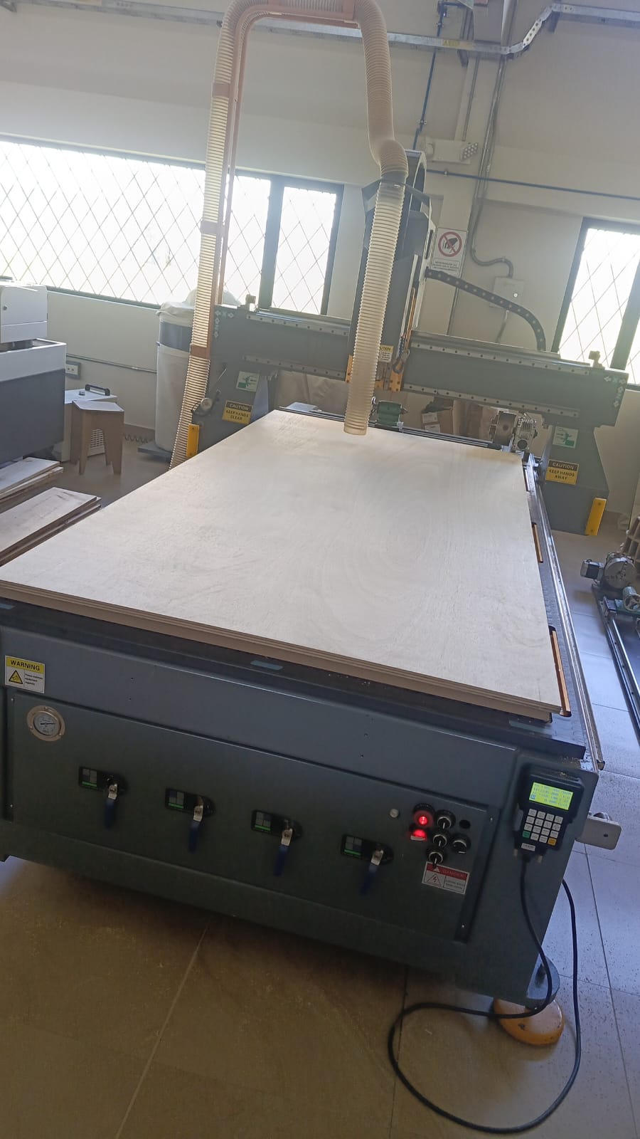 CNC cutting process on plywood board