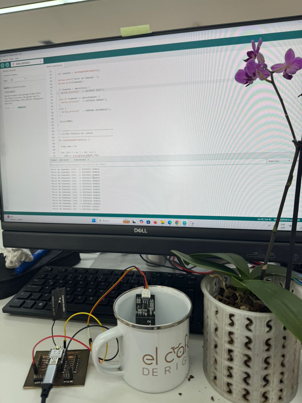 Close-up of the sensor, XIAO PCB and Arduino IDE during the water test