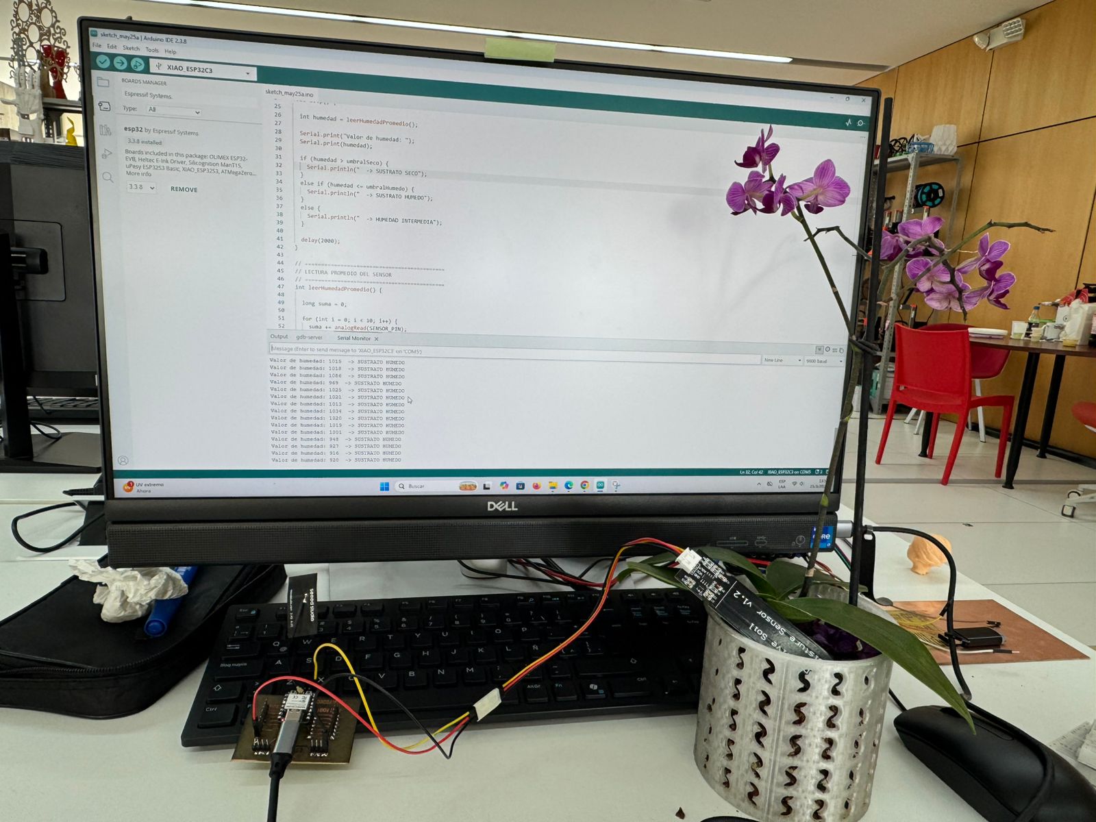 Arduino IDE showing sensor code and Serial Monitor values with the XIAO PCB connected